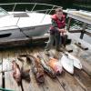 Tom Dame standing with their morning catch of Cod and Halibut.